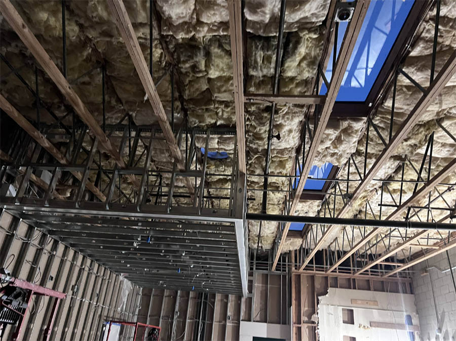 A spacious attic completely lined with thick fiberglass insulation, focusing on coverage and energy conservation techniques.